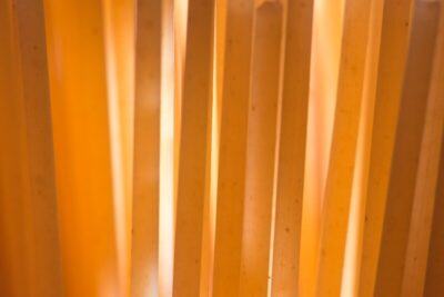brown wooden fence near yellow wall
